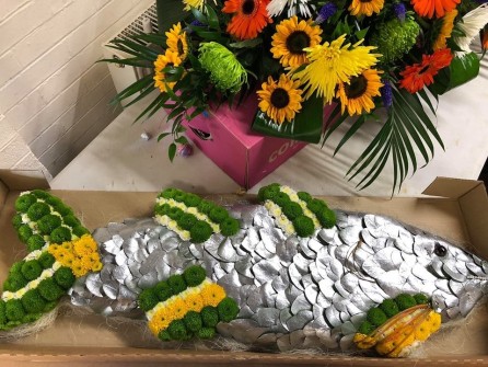 Fish by funeral flowers by Sally Ann